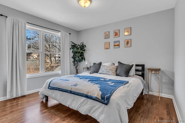 bedroom featuring baseboards and wood finished floors