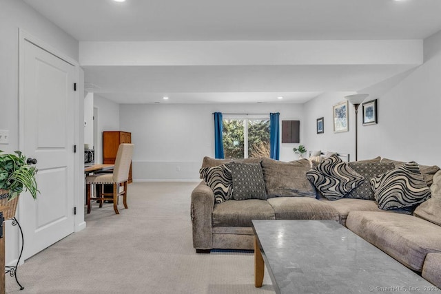 living room with recessed lighting, baseboards, and light colored carpet