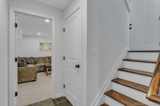 staircase with tile patterned flooring, recessed lighting, and carpet floors