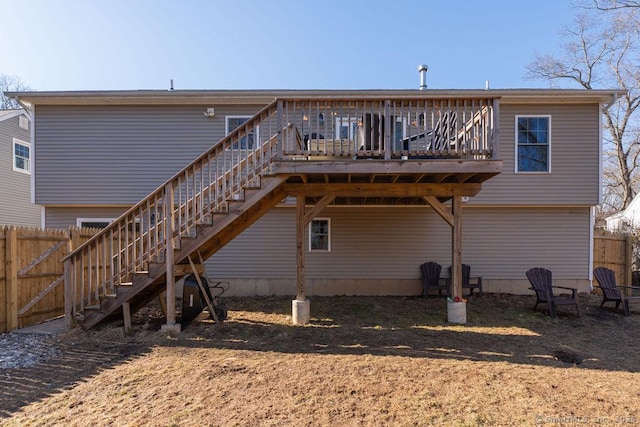 back of property featuring stairway, a wooden deck, and fence