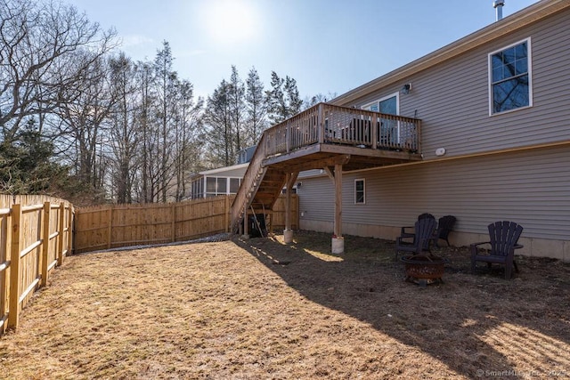 view of yard featuring stairway, a deck, a fire pit, and fence private yard