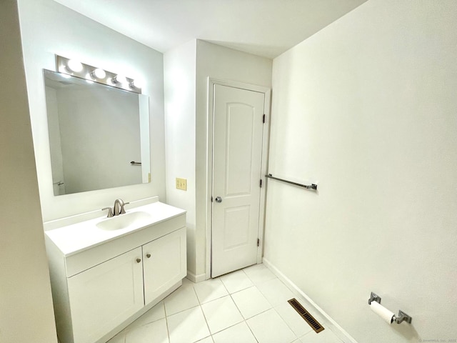 bathroom with tile patterned flooring, visible vents, baseboards, and vanity