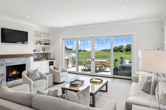 living room with light wood-style floors, crown molding, and plenty of natural light