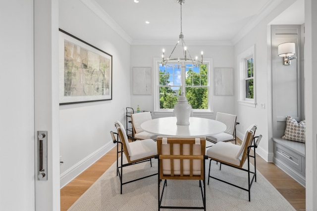 dining area with ornamental molding, light wood-type flooring, and baseboards