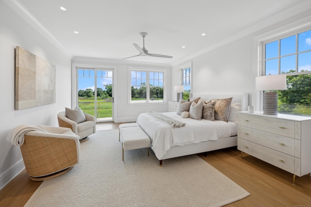 bedroom featuring access to exterior, ornamental molding, wood finished floors, and recessed lighting