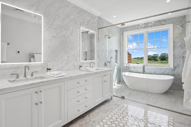 bathroom featuring double vanity, a soaking tub, a sink, and a shower with shower door