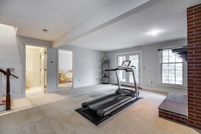 exercise area featuring carpet flooring and baseboards