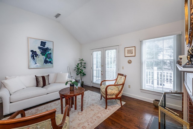 living area featuring visible vents, french doors, baseboards, dark wood-style flooring, and vaulted ceiling