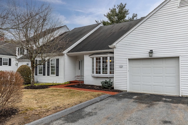 view of front of house with a garage and aphalt driveway