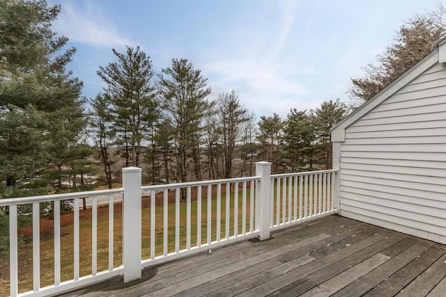 wooden deck with a lawn