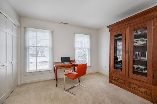 home office with visible vents, light colored carpet, and baseboards