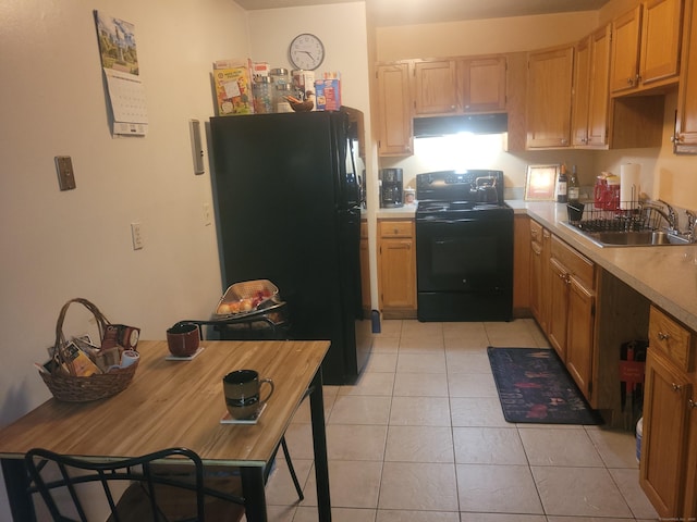 kitchen with light tile patterned floors, light countertops, black appliances, a sink, and exhaust hood