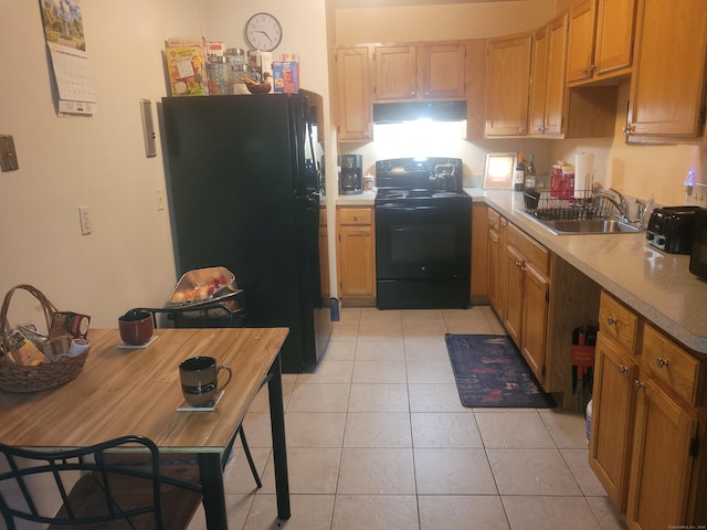 kitchen featuring light tile patterned floors, a sink, black appliances, and extractor fan