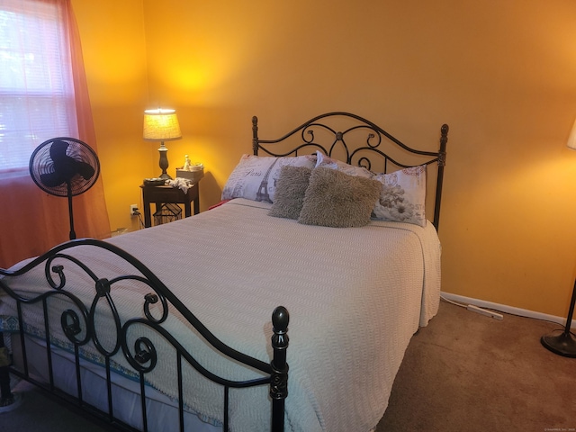 bedroom with carpet floors and baseboards