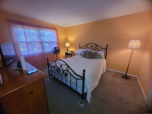 carpeted bedroom featuring baseboards