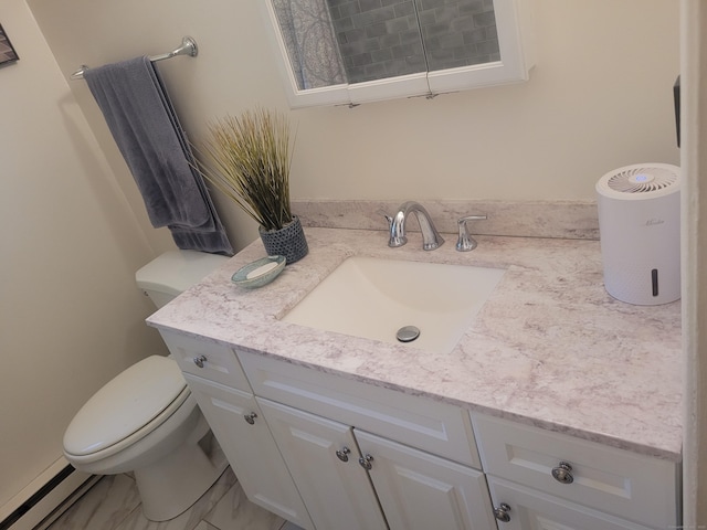 bathroom with a baseboard radiator, vanity, and toilet