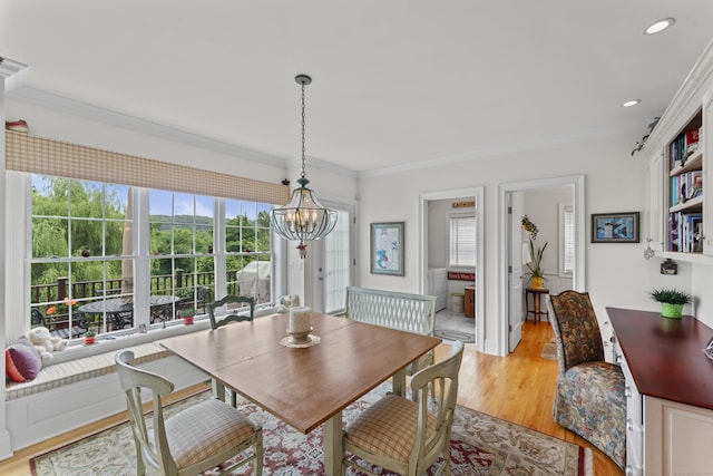 dining room featuring a chandelier, recessed lighting, crown molding, and light wood-style flooring