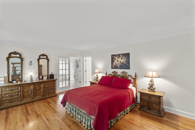 bedroom featuring baseboards, ornamental molding, and wood finished floors