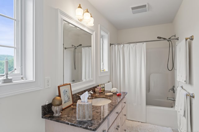 bathroom featuring shower / tub combo, visible vents, and vanity