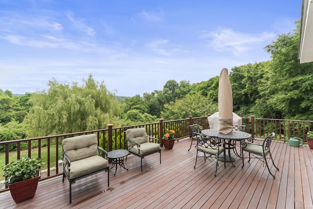 wooden terrace featuring outdoor dining space