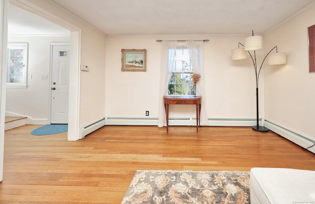 interior space featuring ornamental molding and light wood-style flooring