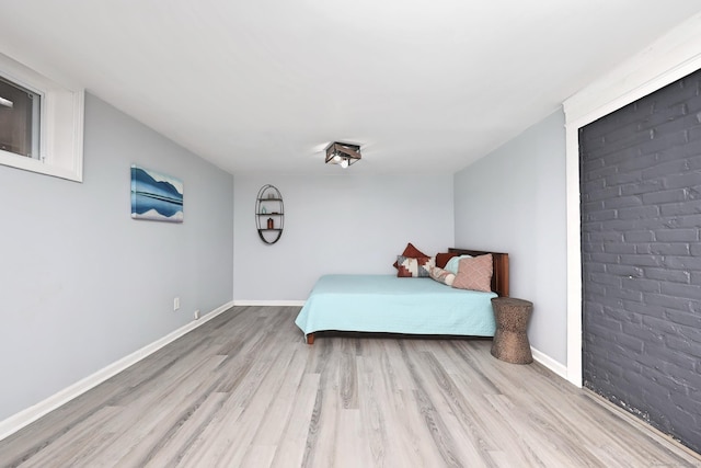 bedroom featuring light wood-style flooring and baseboards