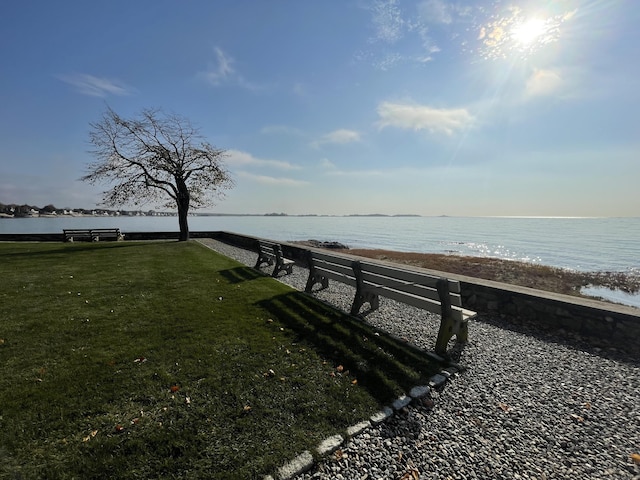 view of dock featuring a water view and a lawn