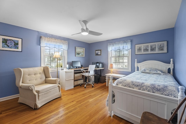 bedroom featuring a ceiling fan, light wood-type flooring, and baseboards