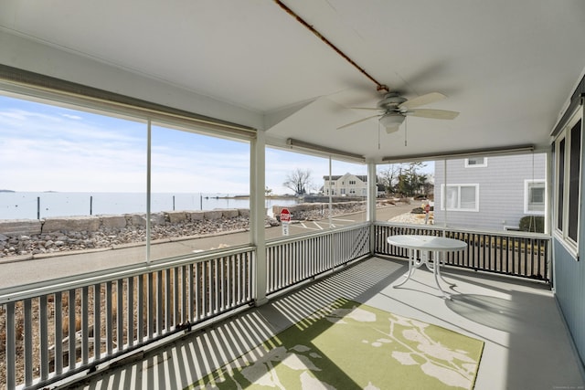 sunroom / solarium featuring ceiling fan