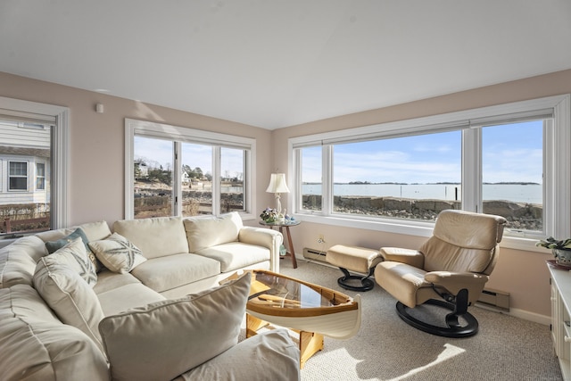 carpeted living room with a baseboard heating unit, a baseboard radiator, vaulted ceiling, and baseboards