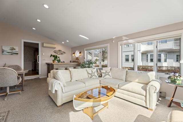 living room with a wall unit AC, lofted ceiling, recessed lighting, light carpet, and baseboards