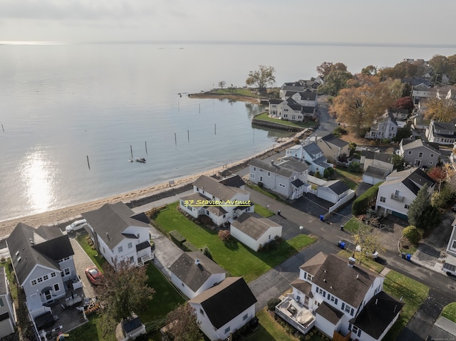 drone / aerial view with a water view and a residential view