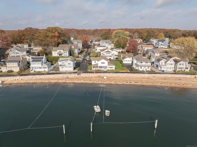 drone / aerial view featuring a water view and a residential view