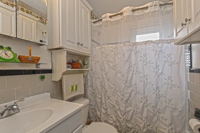 bathroom with toilet, a shower with shower curtain, plenty of natural light, and tile walls