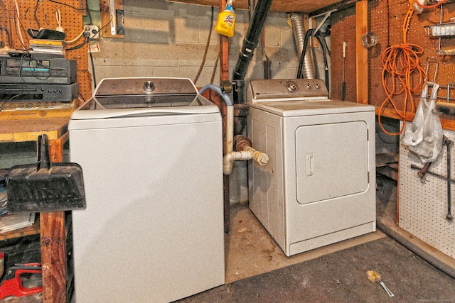 laundry area with washing machine and dryer, laundry area, and concrete block wall