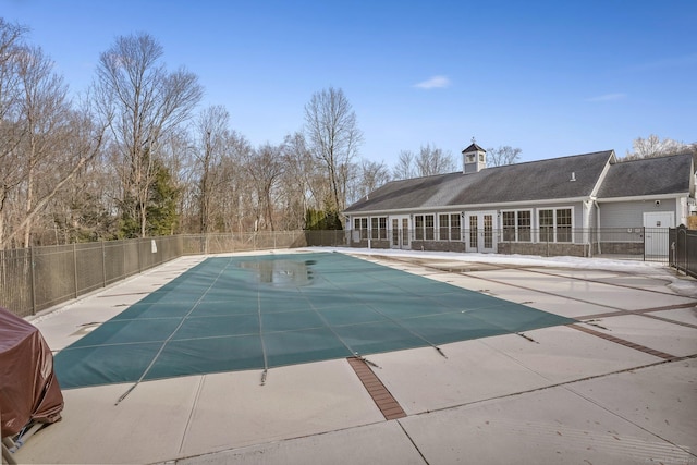 view of swimming pool with a patio, french doors, fence, and a fenced in pool