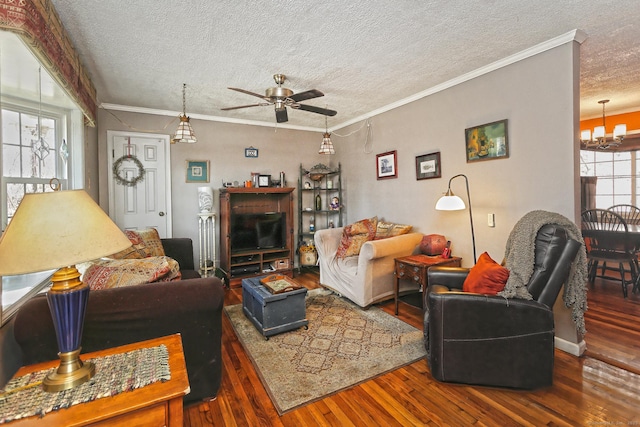 living area with hardwood / wood-style flooring, ornamental molding, ceiling fan with notable chandelier, and a textured ceiling