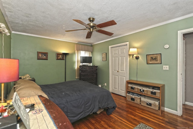 bedroom featuring crown molding, ceiling fan, baseboards, wood finished floors, and a textured ceiling