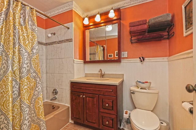 full bathroom featuring toilet, shower / bath combo, wainscoting, tile patterned floors, and vanity