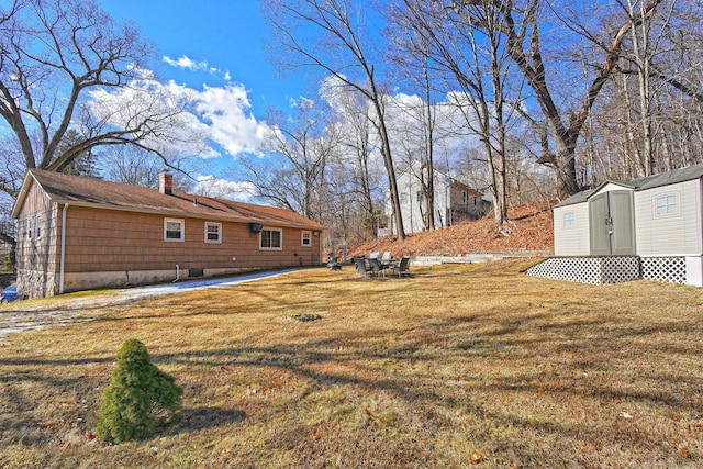 view of yard with a storage shed and an outdoor structure