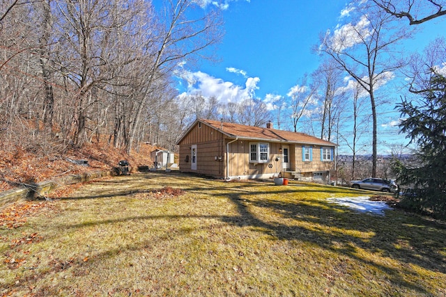 view of front of property with a front lawn and a chimney