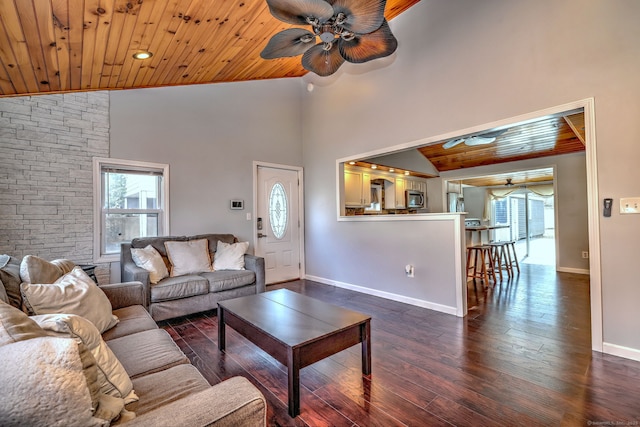 living area featuring ceiling fan, plenty of natural light, and wooden ceiling