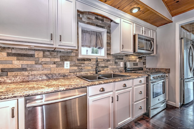 kitchen with backsplash, dark wood-style floors, white cabinets, stainless steel appliances, and a sink