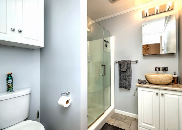 bathroom featuring baseboards, toilet, a stall shower, and ornamental molding