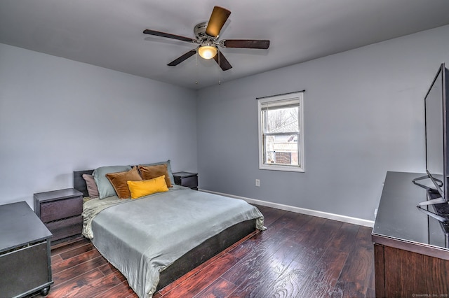 bedroom featuring a ceiling fan, baseboards, and hardwood / wood-style flooring