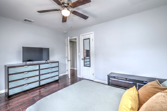 bedroom with visible vents, baseboards, wood finished floors, and a ceiling fan