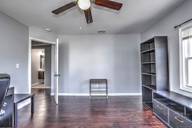 home office with visible vents, a ceiling fan, baseboards, and wood finished floors