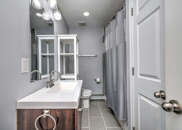 bathroom with visible vents, toilet, vanity, and a baseboard radiator