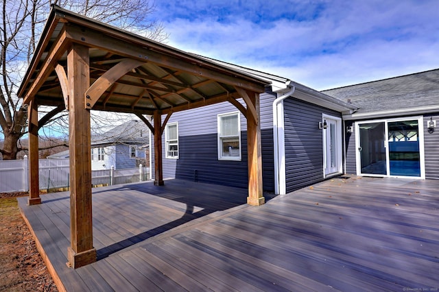 wooden deck featuring a gazebo and fence