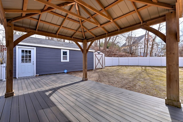 deck with an outbuilding and fence